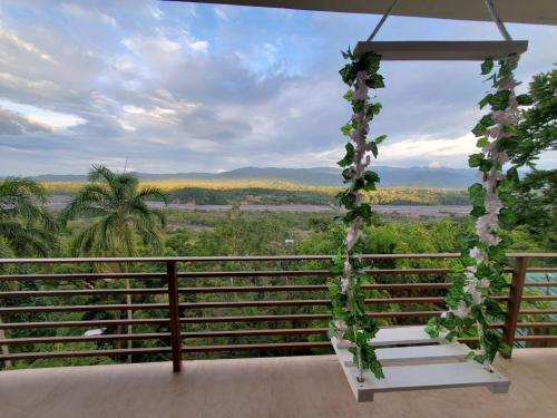 a room with a arch with flowers and a view at Beautiful view suite Suite vista hermosa in Macas