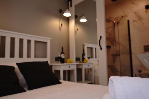 a bedroom with a bed and a glass shower at ACHİLLES BOZCAADA in Bozcaada