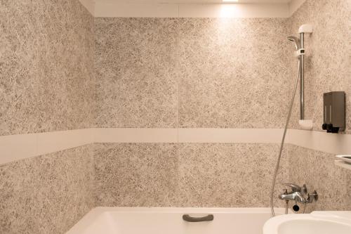 a bathroom with a tub and a sink at HUB HOTEL Tucheng in Tucheng