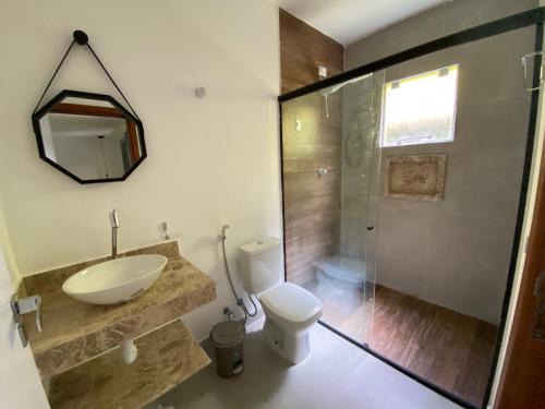 a bathroom with a toilet and a sink and a shower at Villa Suites Gostoso - Condomínio Beira-mar in São Miguel do Gostoso