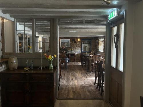 a hallway with a dining room and a dining table at The Talbot Inn in Eynsham