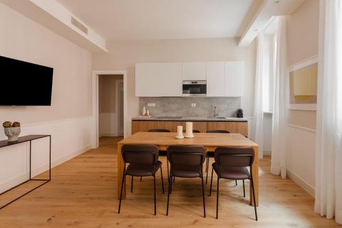 a kitchen and dining room with a wooden table and chairs at Sonder Antinoo in Rome