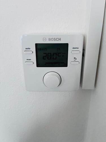 an alarm clock on a wall with a clock on it at Apartmá Luxura in Děčín