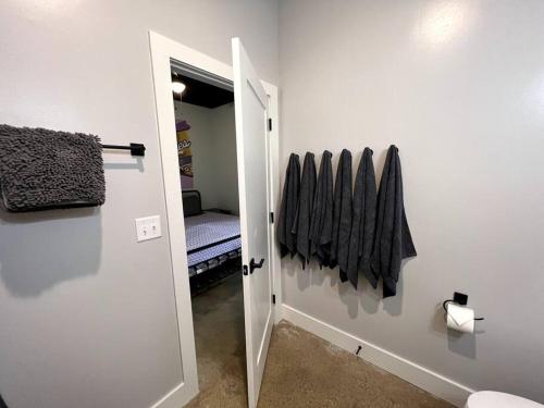 a hallway with a door to a room with a bed at BNA Carpet Condo - 4 miles to DT in Nashville