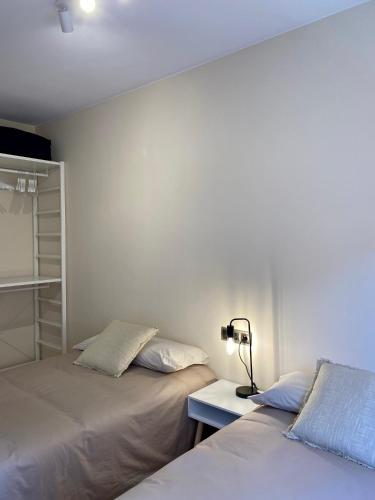 two beds sitting next to each other in a bedroom at Atico duplex en Malgrat de Mar in Malgrat de Mar