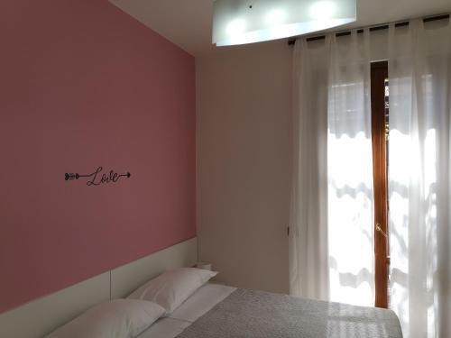 a bedroom with a bed and a window at BeB I PORTICI in Cernobbio