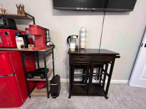 a small table next to a red refrigerator at HomeTel Premium Guest Suite w/ Private Entrance in Ypsilanti
