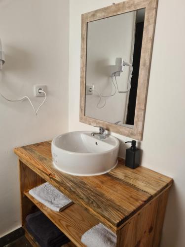 a bathroom with a sink and a mirror at CASA SAO DOMINGOS in Setúbal
