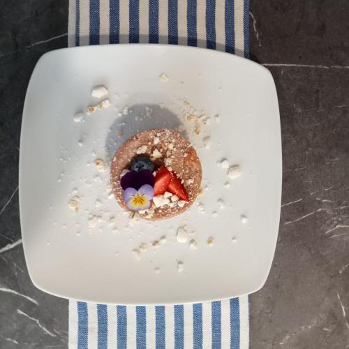 a plate with a donut with fruit in it at SANTINO'S HOUSE in Peveragno