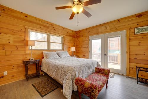 a bedroom with a bed and a ceiling fan at Maggie Valley Cabin with Private Hot Tub and Game Room in Maggie Valley