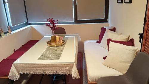 a small room with a table and a couch at Dimitra's traditional house in Katarráktis