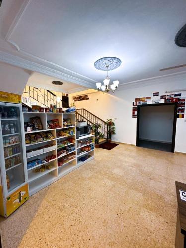a large room with a large refrigerator and stairs at Panorama Jerash HOTEL (2) in Jerash