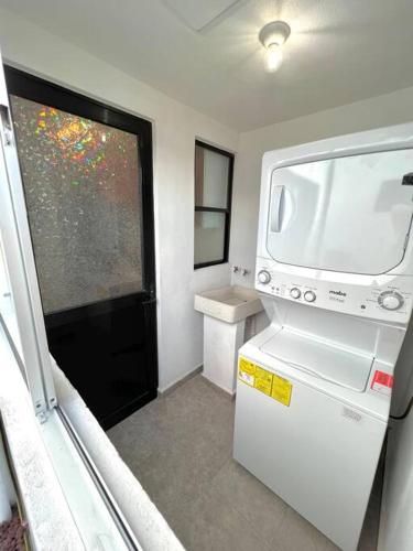a small kitchen with a refrigerator and a window at Luxury Apartment with Great Location 2-A in Matamoros