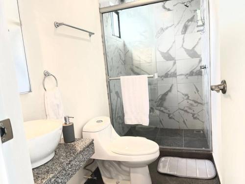 a bathroom with a toilet and a sink and a shower at Luxury Apartment with Great Location 2-A in Matamoros