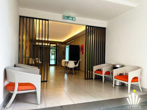 a lobby with chairs and tables in a building at The Shore Hotel & Residences By Lá VISTA in Melaka