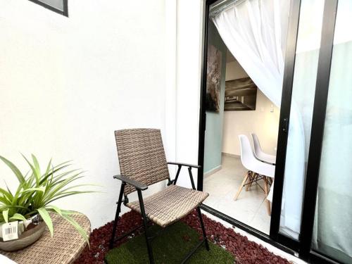 a chair sitting on the balcony of a house at Luxury Apartment with Great Location 2-A in Matamoros