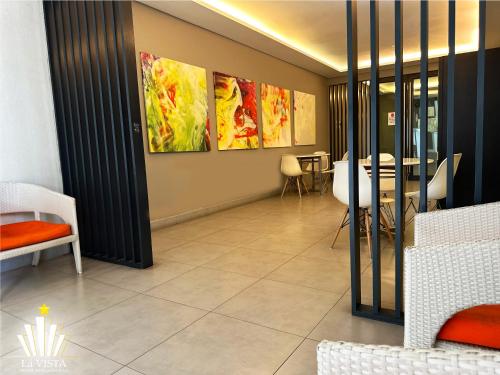 a dining room with paintings on the wall at The Shore Hotel & Residences By Lá VISTA in Melaka