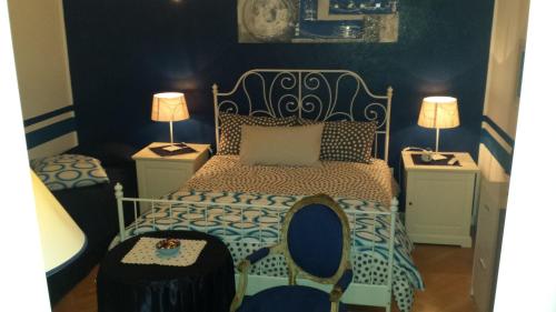 a bedroom with a bed and two night stands at B&B Gasiso in Monfalcone