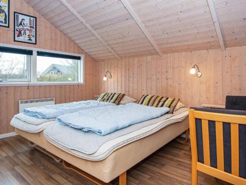 a bedroom with a large bed in a room at Three-Bedroom Holiday home in Hemmet 55 in Hemmet