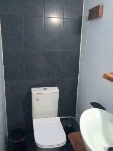 a bathroom with a white toilet and a sink at Clock's House in Nafpaktos