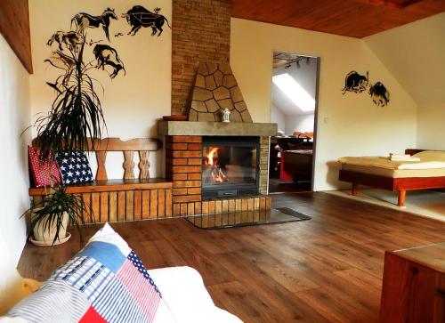 a living room with a fireplace in a living room at Penzion Bor in Náchod