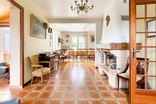 un salon avec cheminée et une salle à manger dans l'établissement Maison familiale avec grand jardin - proche mer, à Crach