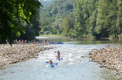 a group of people on kayaks in a river at El Mirador del Sella in Arriondas