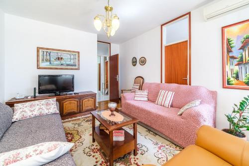 a living room with two couches and a tv at Apartment 123 for you in Split