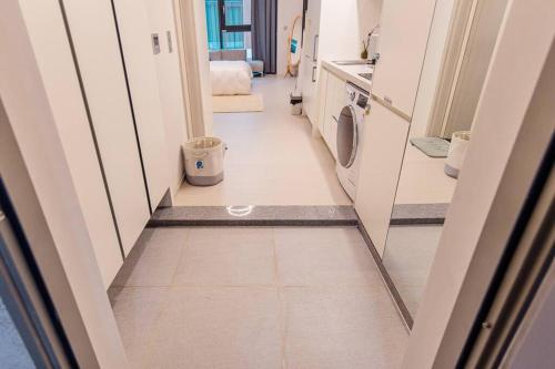 a hallway of a bathroom with a washing machine at The Castle Ocean Marina Double Suite in Yeosu