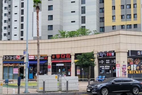 a black car parked in front of a building at The Castle Ocean Marina Double Suite in Yeosu