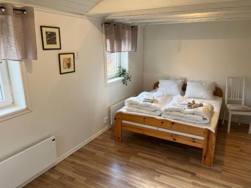 a bedroom with a bed with blankets and pillows at Guest House Stare in Strömstad