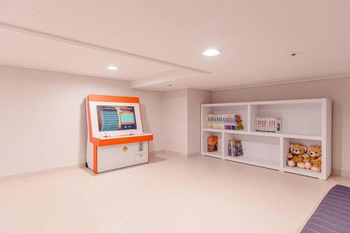 a room with a computer on a desk and shelves at The Castle Ocean Marina Double Suite in Yeosu