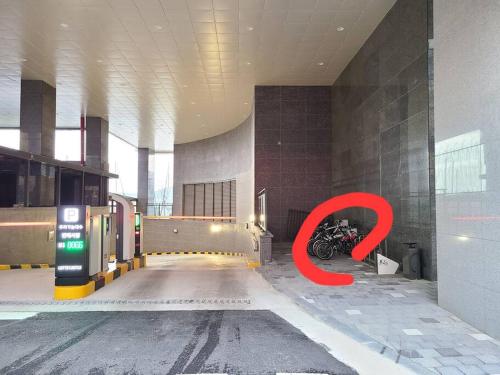 a red sign in the middle of a building with a motorcycle at The Castle Ocean Marina Double Suite in Yeosu