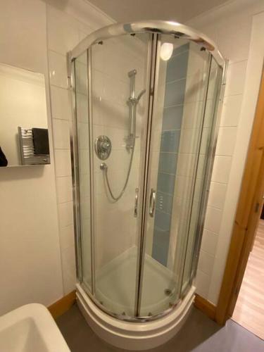 a shower in a bathroom with a glass shower stall at 1 bedroom apartment in Norwich city centre in Norwich