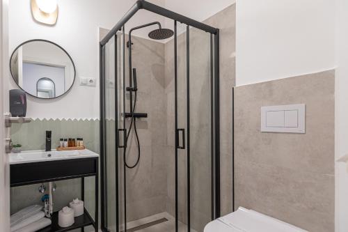 a bathroom with a shower with a toilet and a sink at Richter Residence in Braşov