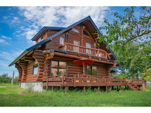 a log cabin with a porch and a deck at Inaka no Kakurega Cottage Hideaway - Vacation STAY 19620v in Inakadate