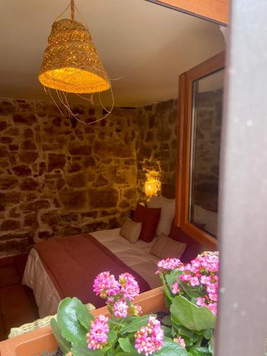 a bedroom with a bed in a room with flowers at Posada de Lola in El Molar