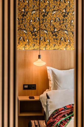 a bedroom with a bed and a painting on the wall at Afterwork Hotel in Etoy