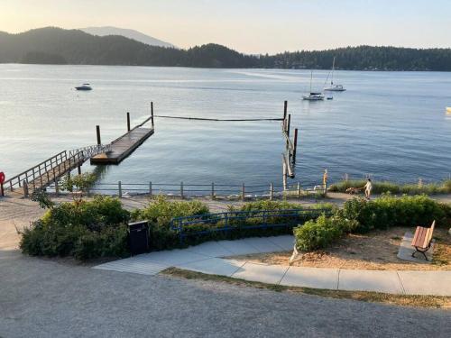 a dock on a lake with boats in the water at Iconic 3-Story Waterfront 'Marina House' w/ View in Gibsons