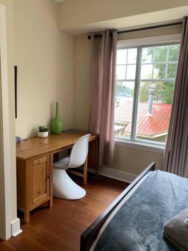 a desk with a chair and a window in a room at Iconic 3-Story Waterfront 'Marina House' w/ View in Gibsons