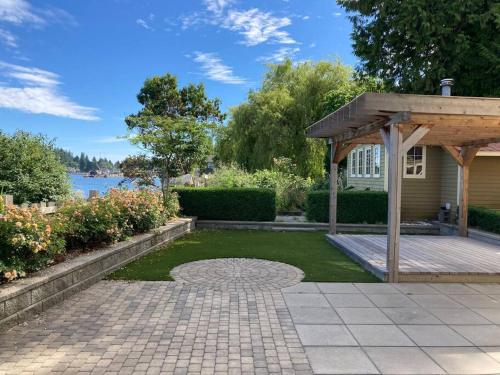 a backyard with a patio and a gazebo at Iconic 3-Story Waterfront 'Marina House' w/ View in Gibsons