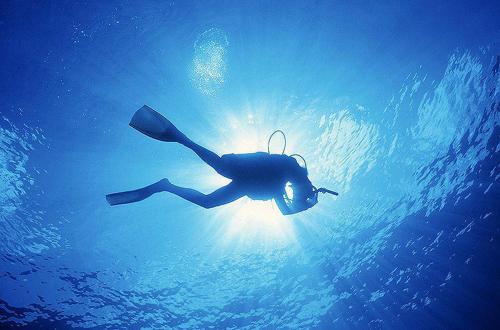 una persona nadando en el agua con una sombrilla en STUDIO APARTMAN "Daria", en Kostrena