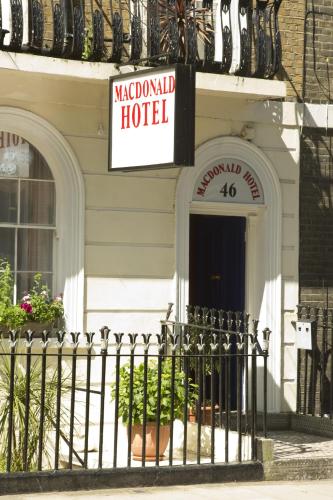 a sign for a madrid hotel on the side of a building at Macdonald Hotel in London