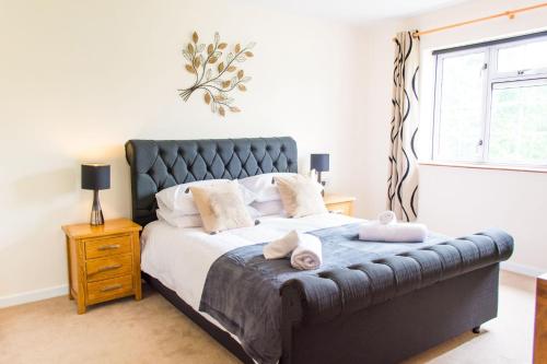 a bedroom with a large bed with towels on it at The Hideaway - Norfolk Holiday Properties in Wells next the Sea