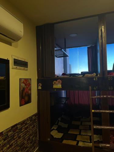 a room with a bunk bed and a window at Petra cabin Roof top hostel in Wadi Musa
