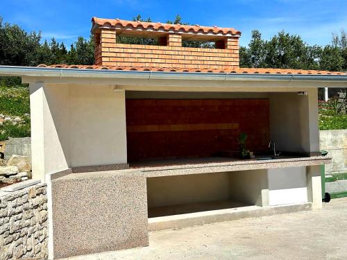 a garage with a roof on top of it at Villa Lucia with private pool and a whirlpool in Vis