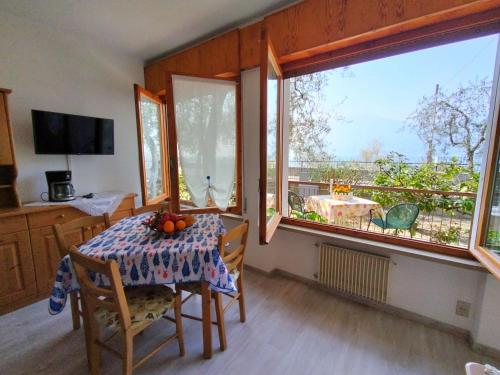 a dining room with a table with fruit on it at Lorena house in Brenzone sul Garda