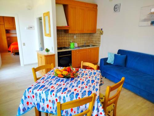 a kitchen with a table with a bowl of fruit on it at Lorena house in Brenzone sul Garda