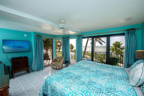 a bedroom with a bed and a view of the ocean at Mar Y Sol Ocean Front in Key West