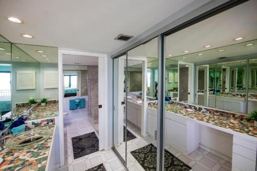 a bathroom with multiple sinks and mirrors at Mar Y Sol Ocean Front in Key West